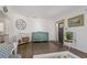 Bright entryway with decorative wall art, accent furniture, and dark flooring at 3113 W Sligh Ave, Tampa, FL 33614