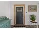 Bright entryway with decorative wall art, accent furniture, and dark flooring at 3113 W Sligh Ave, Tampa, FL 33614