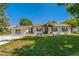 Charming single-story home with a well-manicured lawn and inviting front porch with decorative wreath at 3113 W Sligh Ave, Tampa, FL 33614