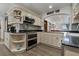 Well-equipped kitchen featuring black granite countertops, wooden cabinets, and modern stainless steel appliances at 3113 W Sligh Ave, Tampa, FL 33614