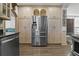 Kitchen featuring stainless steel refrigerator and custom cabinets for ample storage solutions at 3113 W Sligh Ave, Tampa, FL 33614