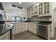 Charming kitchen with granite countertops, stainless steel appliances, and a view into the living room at 3113 W Sligh Ave, Tampa, FL 33614