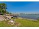 Beautiful lakefront with a sandy beach, dock, and calm water, perfect for enjoying water activities at 3113 W Sligh Ave, Tampa, FL 33614