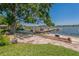 Charming lakeside area with a picnic table, swing, and dock, perfect for relaxation and recreation at 3113 W Sligh Ave, Tampa, FL 33614