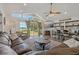 Spacious living room with lake views, wood flooring, and comfortable seating with ceiling fan at 3113 W Sligh Ave, Tampa, FL 33614