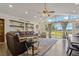 Bright living room featuring a vaulted ceiling, hardwood floors, and sliding glass doors to the outside at 3113 W Sligh Ave, Tampa, FL 33614