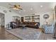 Cozy living room featuring hardwood floors, a large sectional sofa, and stylish decor elements at 3113 W Sligh Ave, Tampa, FL 33614