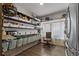 Well-organized pantry features ample shelving, baskets, and natural light from the adjacent window at 3113 W Sligh Ave, Tampa, FL 33614
