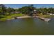 Picturesque waterfront property with private beach, dock, boat and jet ski lift and mature trees at 3113 W Sligh Ave, Tampa, FL 33614