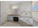 Bright bathroom with a soaking tub, separate vanity, and large window for natural light at 31382 Chesapeake Bay Dr, Wesley Chapel, FL 33543