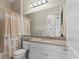 Bathroom with shower/tub combination, granite counters, and natural light at 31382 Chesapeake Bay Dr, Wesley Chapel, FL 33543