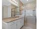 Bright bathroom features granite counters, white cabinets, and a glass-enclosed shower at 31382 Chesapeake Bay Dr, Wesley Chapel, FL 33543