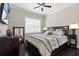 Bedroom featuring hardwood floors, a ceiling fan, a large window, and dresser at 31382 Chesapeake Bay Dr, Wesley Chapel, FL 33543