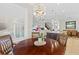 Comfortable dining area with a chandelier, views to the living area, and natural light at 31382 Chesapeake Bay Dr, Wesley Chapel, FL 33543