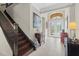 Elegant foyer with staircase, decorative furnishings and a view of the front entrance at 31382 Chesapeake Bay Dr, Wesley Chapel, FL 33543