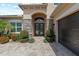 Elegant front entrance featuring stone pillars, a covered entryway, and a beautifully paved driveway at 31382 Chesapeake Bay Dr, Wesley Chapel, FL 33543