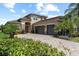 Charming two-story home with stone accents, a paved driveway, two-car garage, and meticulously manicured landscaping at 31382 Chesapeake Bay Dr, Wesley Chapel, FL 33543