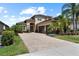 Beautiful two-story home featuring a paved driveway, two-car garage, stone accents, and mature landscaping at 31382 Chesapeake Bay Dr, Wesley Chapel, FL 33543
