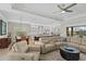 Open living area with plush sofa and furniture adjacent to the kitchen and dining area at 31382 Chesapeake Bay Dr, Wesley Chapel, FL 33543
