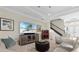 Cozy living room with stylish decor, a large screen TV, and easy access to the staircase at 31382 Chesapeake Bay Dr, Wesley Chapel, FL 33543