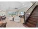 Inviting living room with a comfortable sofa, staircase, and access to outdoor views at 31382 Chesapeake Bay Dr, Wesley Chapel, FL 33543
