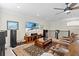 Entertaining space with comfortable seating, TV, speakers, ceiling fan, and lots of natural light at 31382 Chesapeake Bay Dr, Wesley Chapel, FL 33543