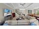 Inviting living room featuring comfortable seating, a large television, and stairs leading to the upper level at 31382 Chesapeake Bay Dr, Wesley Chapel, FL 33543