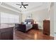 Bedroom with hardwood floors and a tray ceiling, complemented by traditional furnishings at 31382 Chesapeake Bay Dr, Wesley Chapel, FL 33543