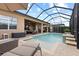 Backyard oasis featuring a screened-in pool, patio furniture, and a relaxing outdoor space at 31382 Chesapeake Bay Dr, Wesley Chapel, FL 33543