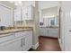Spacious bathroom with double vanities, granite countertops, tile flooring, and stylish fixtures at 314 Crosswinds Dr, Palm Harbor, FL 34683