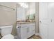 Well lit bathroom with white cabinets, granite countertop, and brushed nickel hardware at 314 Crosswinds Dr, Palm Harbor, FL 34683
