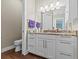 Bathroom featuring granite countertops, a vanity with double sinks, and tile floors at 314 Crosswinds Dr, Palm Harbor, FL 34683