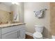 Bathroom with white cabinets, granite countertop, and tiled shower at 314 Crosswinds Dr, Palm Harbor, FL 34683