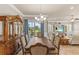 A formal dining room has a chandelier, large window, and a dining set at 314 Crosswinds Dr, Palm Harbor, FL 34683