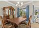 A formal dining room features an elegant dining set, and plenty of natural light at 314 Crosswinds Dr, Palm Harbor, FL 34683