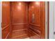 Luxurious wooden elevator cab with paneled walls, integrated lighting, and stainless steel features at 314 Crosswinds Dr, Palm Harbor, FL 34683