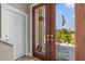 Elegant front door with glass, offering a view of the landscaped yard and American flag at 314 Crosswinds Dr, Palm Harbor, FL 34683