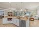 An open concept kitchen has an island, stainless appliances, granite countertops, and modern fixtures at 314 Crosswinds Dr, Palm Harbor, FL 34683