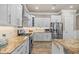 A modern kitchen boasts granite countertops, stainless appliances, and ample storage space at 314 Crosswinds Dr, Palm Harbor, FL 34683