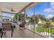 Spacious tiled, screened-in lanai with ceiling fans, a relaxing view and outdoor furniture at 314 Crosswinds Dr, Palm Harbor, FL 34683