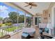 Inviting tiled, screened-in lanai with ceiling fans, outdoor furniture, and backyard view at 314 Crosswinds Dr, Palm Harbor, FL 34683