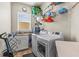 Bright laundry room with sink, front load washer and dryer, and plenty of storage at 314 Crosswinds Dr, Palm Harbor, FL 34683