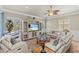 The living area has a large entertainment center, plantation shutters, and comfortable seating at 314 Crosswinds Dr, Palm Harbor, FL 34683