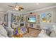 The living area has an entertainment center, plantation shutters, and comfortable seating at 314 Crosswinds Dr, Palm Harbor, FL 34683