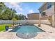The backyard oasis has a refreshing swimming pool and brick paver patio, perfect for relaxing and entertaining at 314 Crosswinds Dr, Palm Harbor, FL 34683