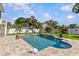 Beautiful backyard pool and patio area surrounded by lush tropical landscaping creating a private oasis at 314 Crosswinds Dr, Palm Harbor, FL 34683
