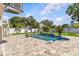 Beautiful backyard pool and patio area surrounded by lush tropical landscaping creating a private oasis at 314 Crosswinds Dr, Palm Harbor, FL 34683