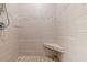Shower featuring decorative tile accents, a built-in bench, and a pebble floor at 314 Crosswinds Dr, Palm Harbor, FL 34683
