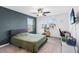 Cozy bedroom features a ceiling fan, natural light, and a vibrant accent wall at 33263 Sycamore Leaf Dr, Wesley Chapel, FL 33545