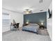 Spacious primary bedroom boasts an accent wall, carpet, and natural light at 33263 Sycamore Leaf Dr, Wesley Chapel, FL 33545